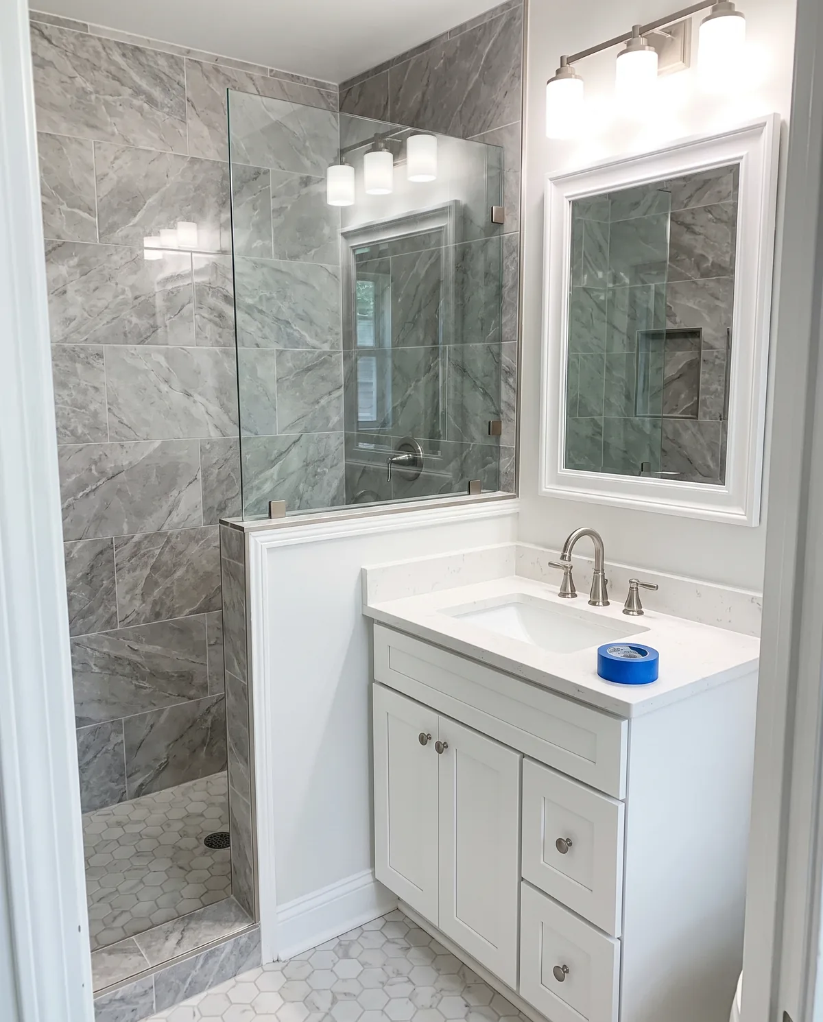 Renovación de baño con regadera de azulejo y tocador blanco
