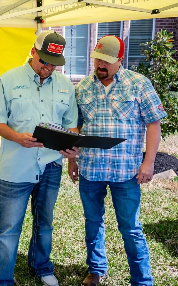 Two Down South team members reviewing paperwork under the company tent